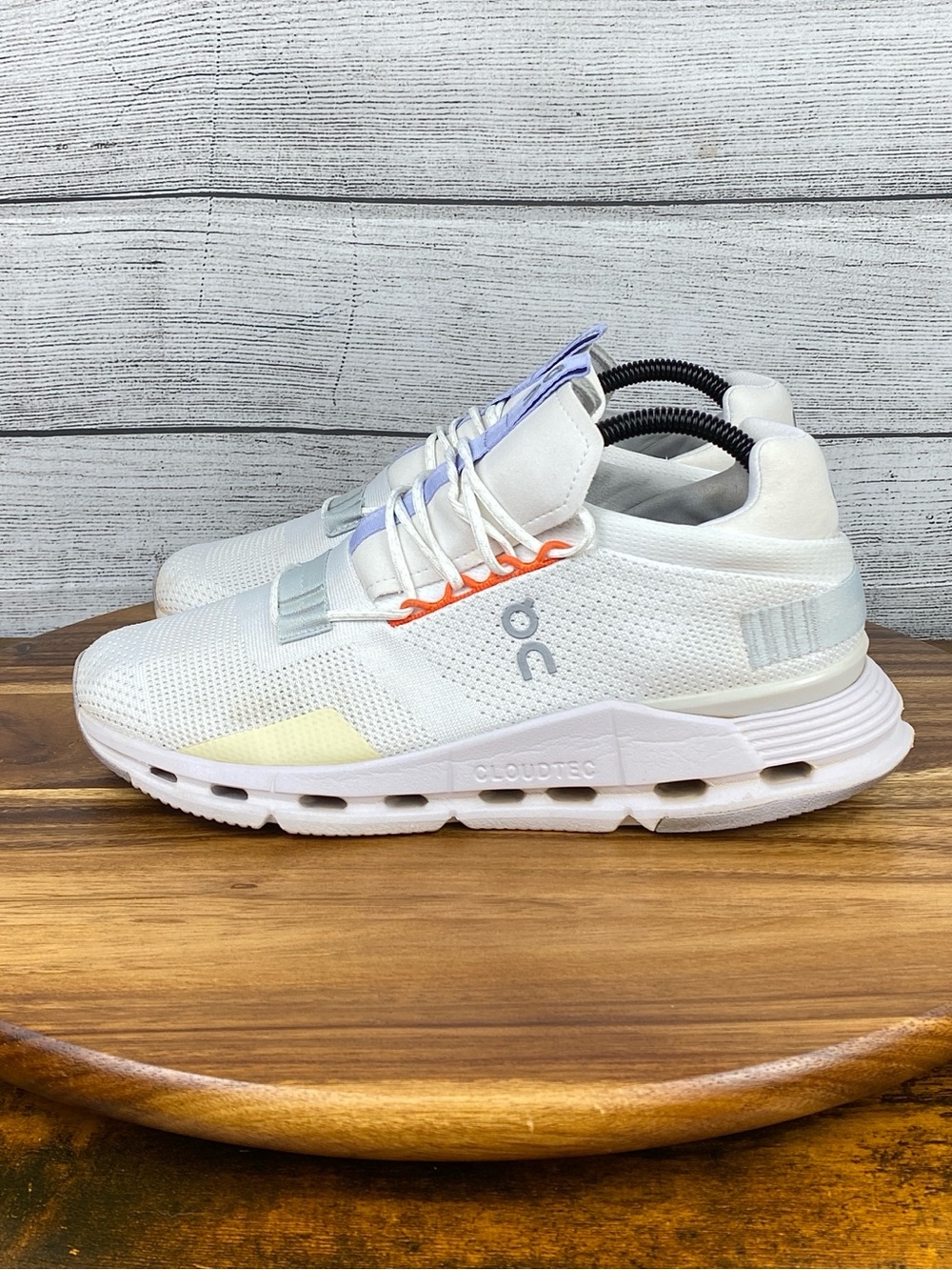 On Running White Athletic Sneakers with Light Purple and Orange Accents